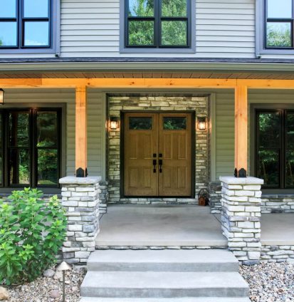 Home with large windows and beautiful double door entrance