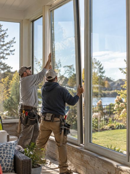 Technician inspecting Window Installation seal points at a Hansen - ID home during exterior finishing, Technician checking Window Installation fit and exterior sealing at a Wilder - ID home